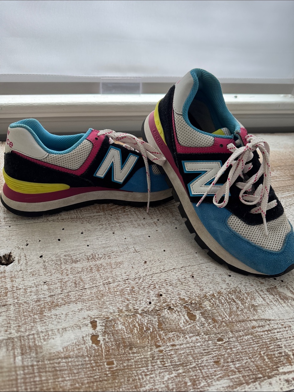 New Balance sneakers. 7.5. WL574
Pink,blue,yellow and white.
